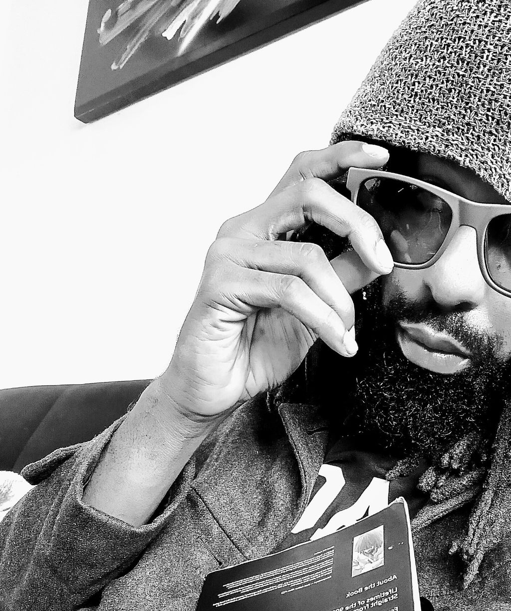 Black and white portrait of DaLegendary1 wearing Grey Lift sunglasses.